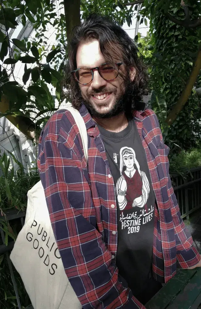 The developer, with nature in the backgroung, smiling